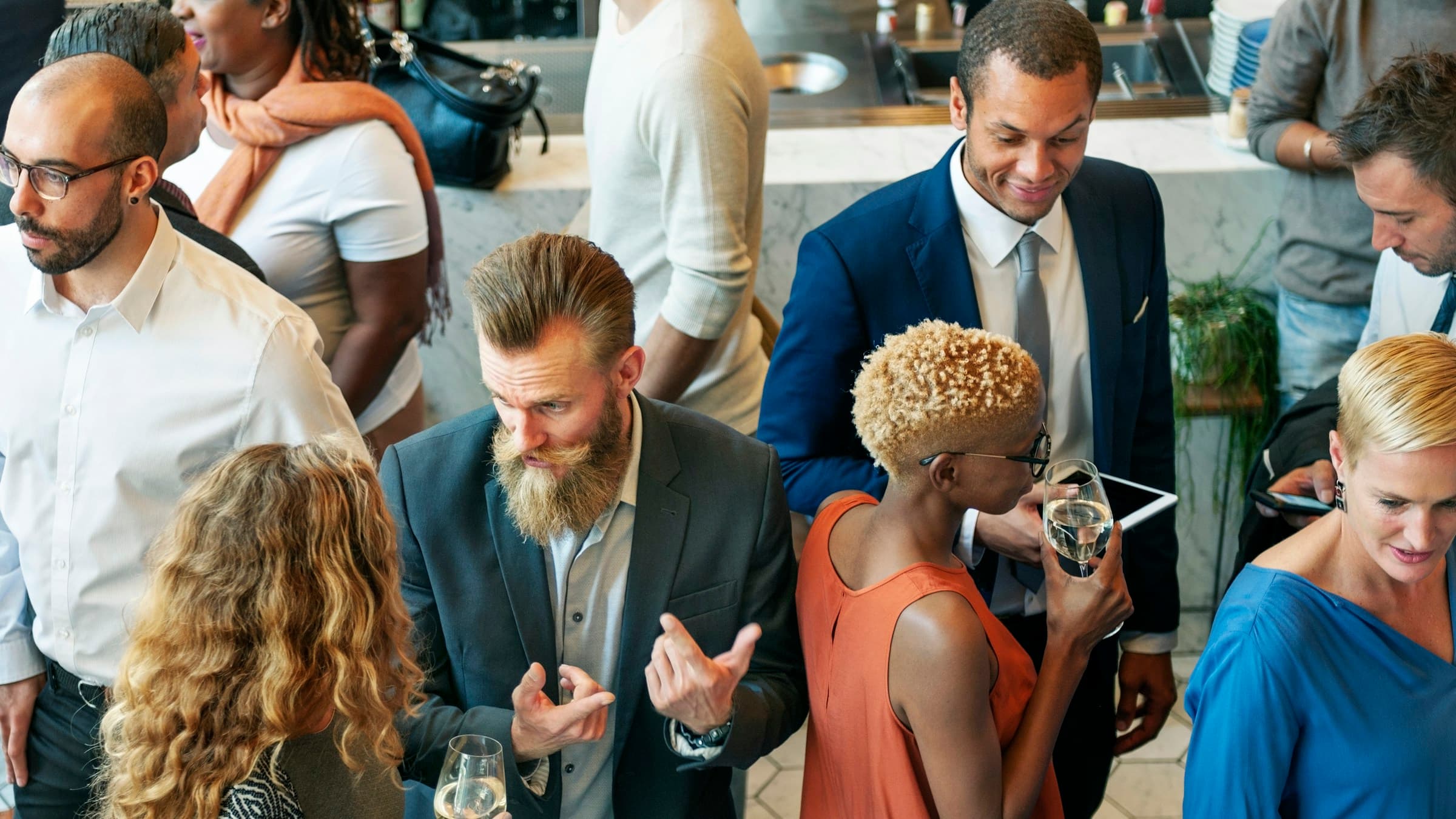 Entrepreneurs and business leaders in conversation at an evening networking reception