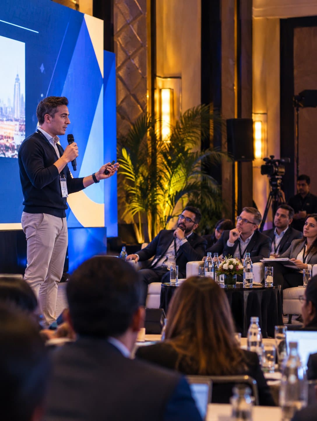 A young founder pitching with a microphone at a start-up event
