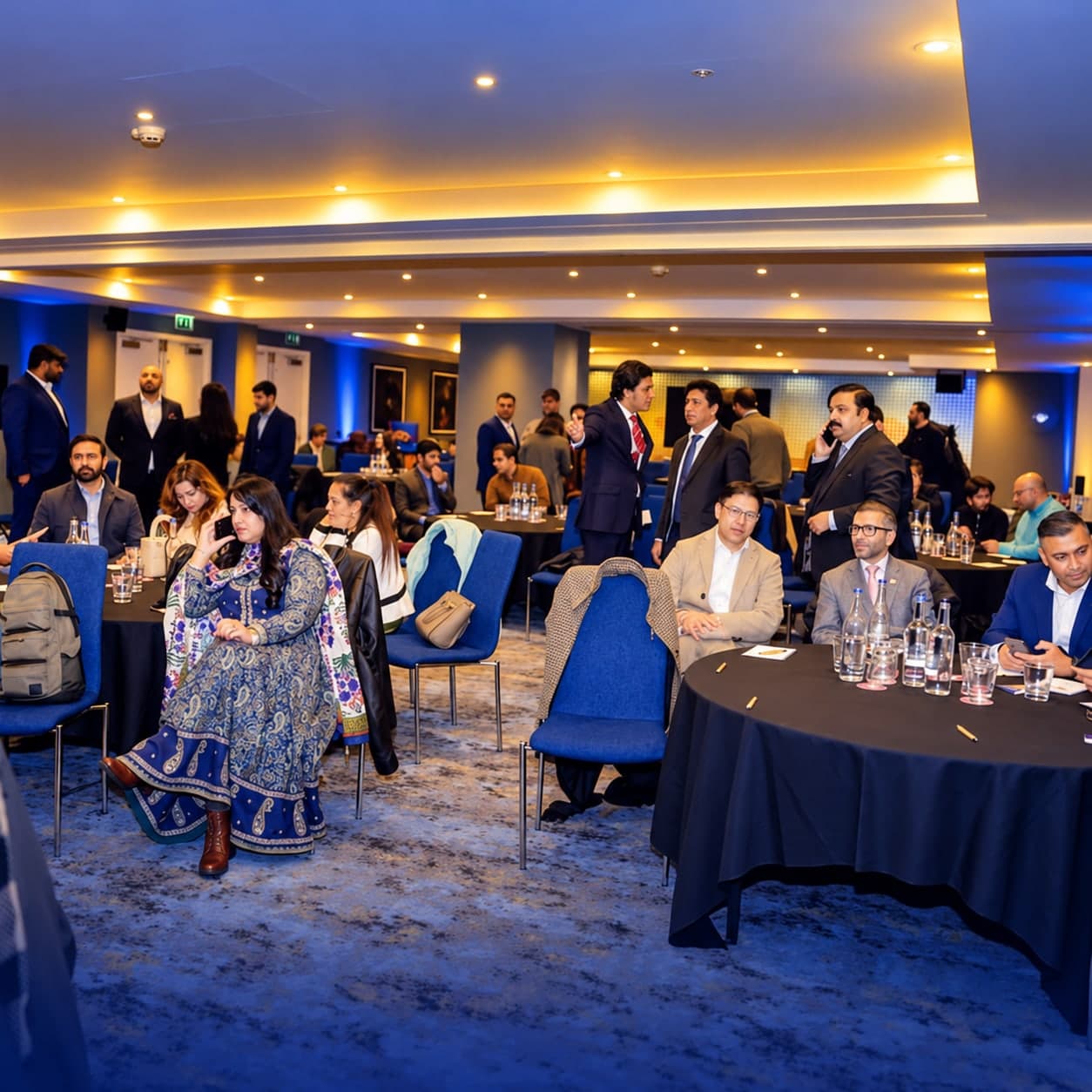 Business guests networking between tables at an international event