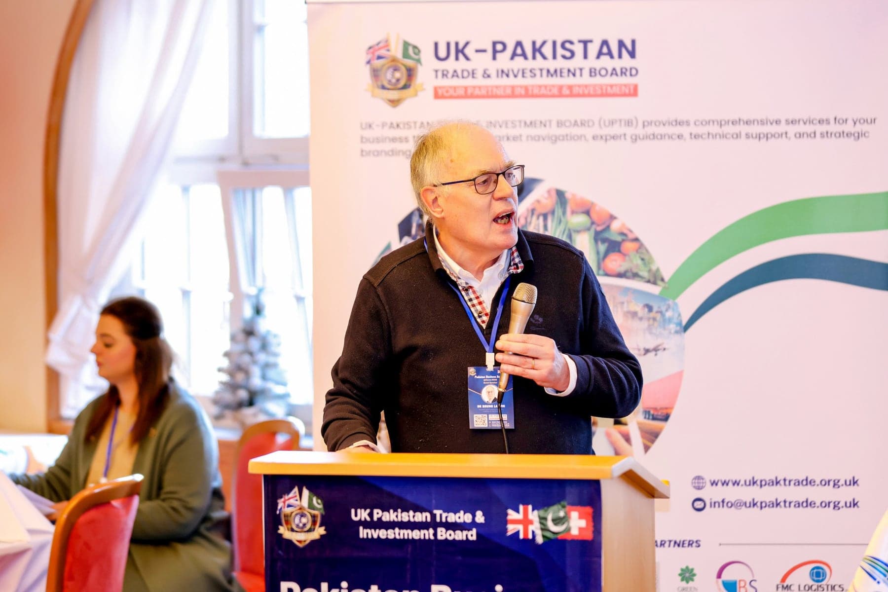 A speaker at the podium of a business forum