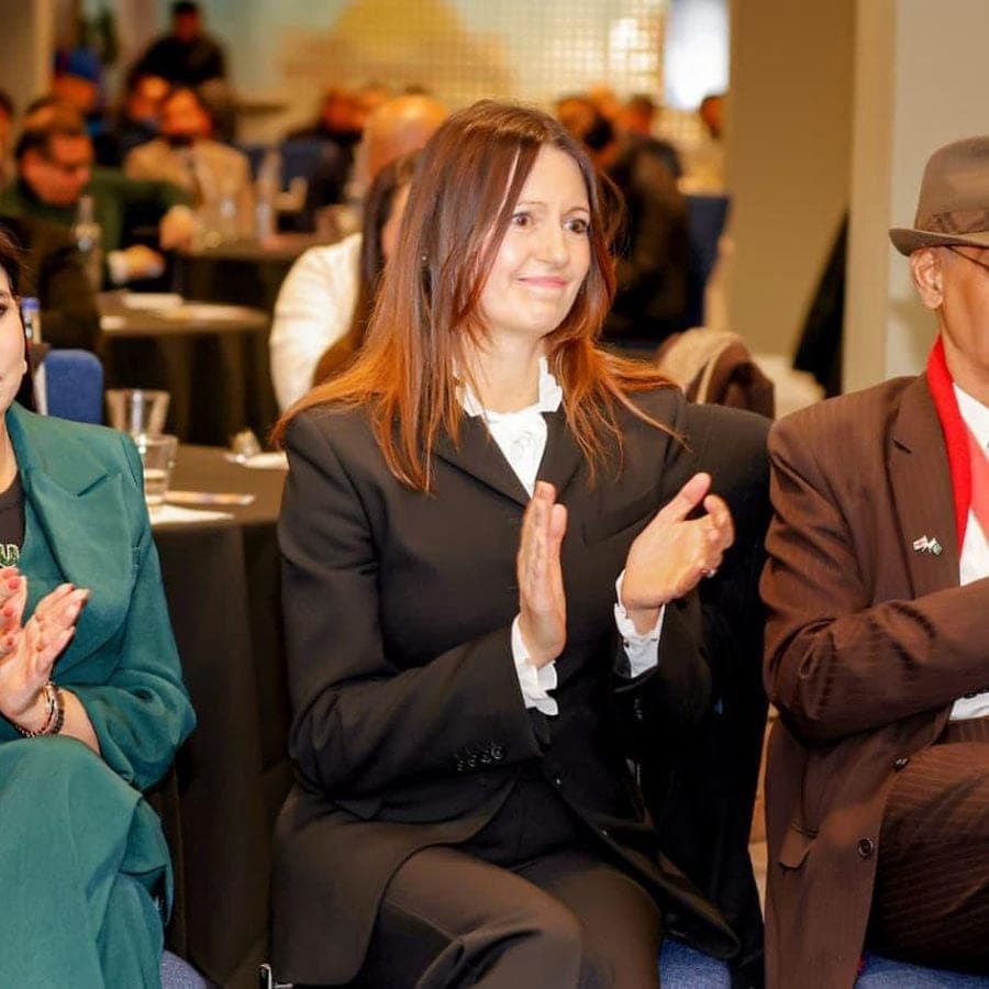 A delegate applauding at a business event
