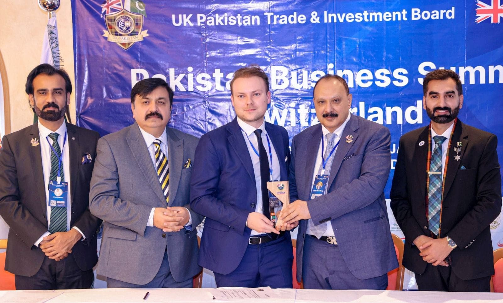 Award recipients holding their trophy with the presenting team