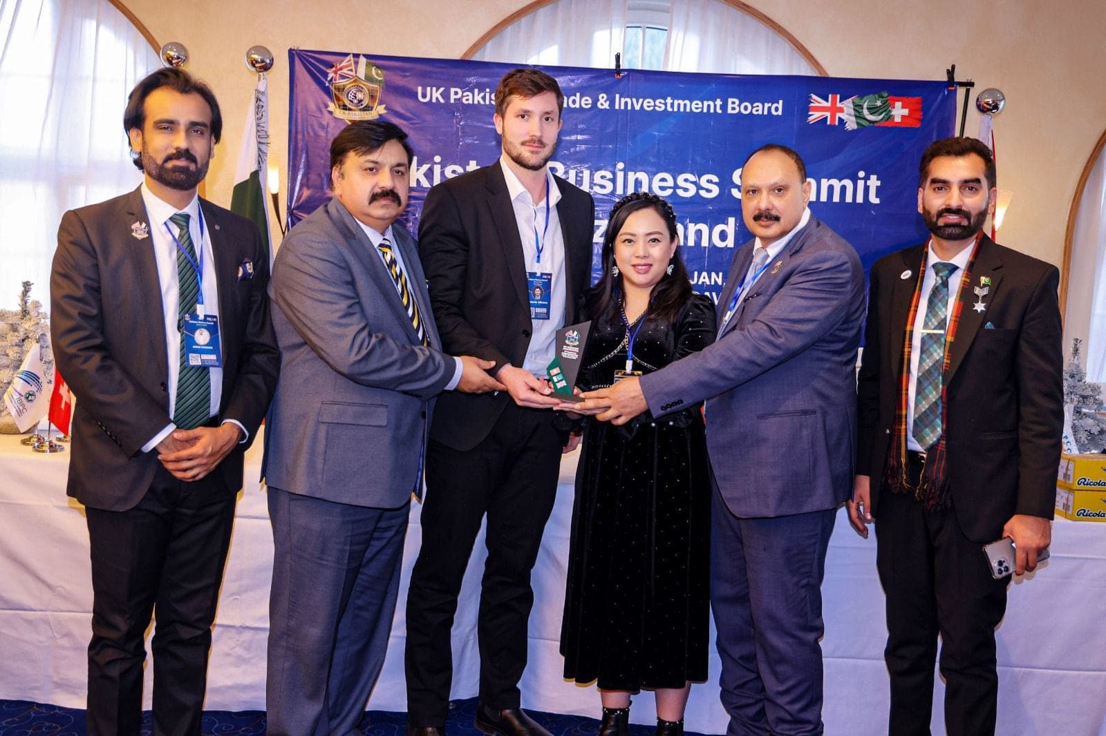 An award being presented on stage at a business summit