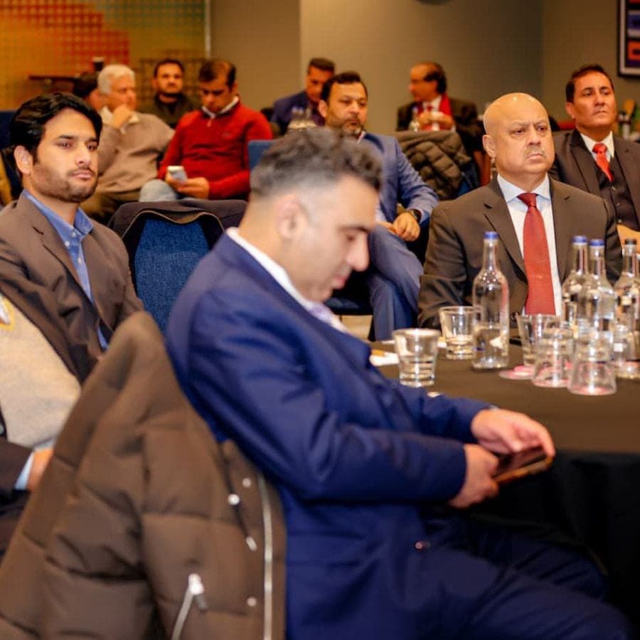Entrepreneurs seated at tables during a session