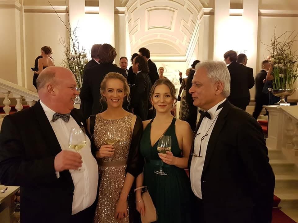 Guests in evening dress at a networking reception
