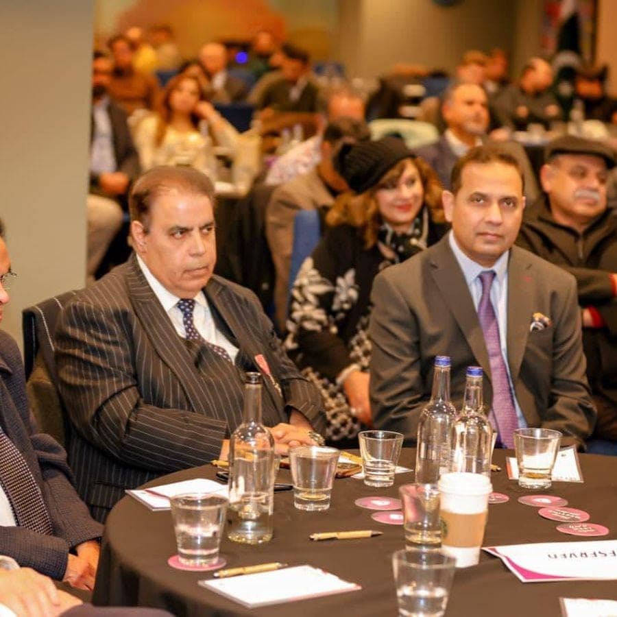 Two executives seated at a table during a business event
