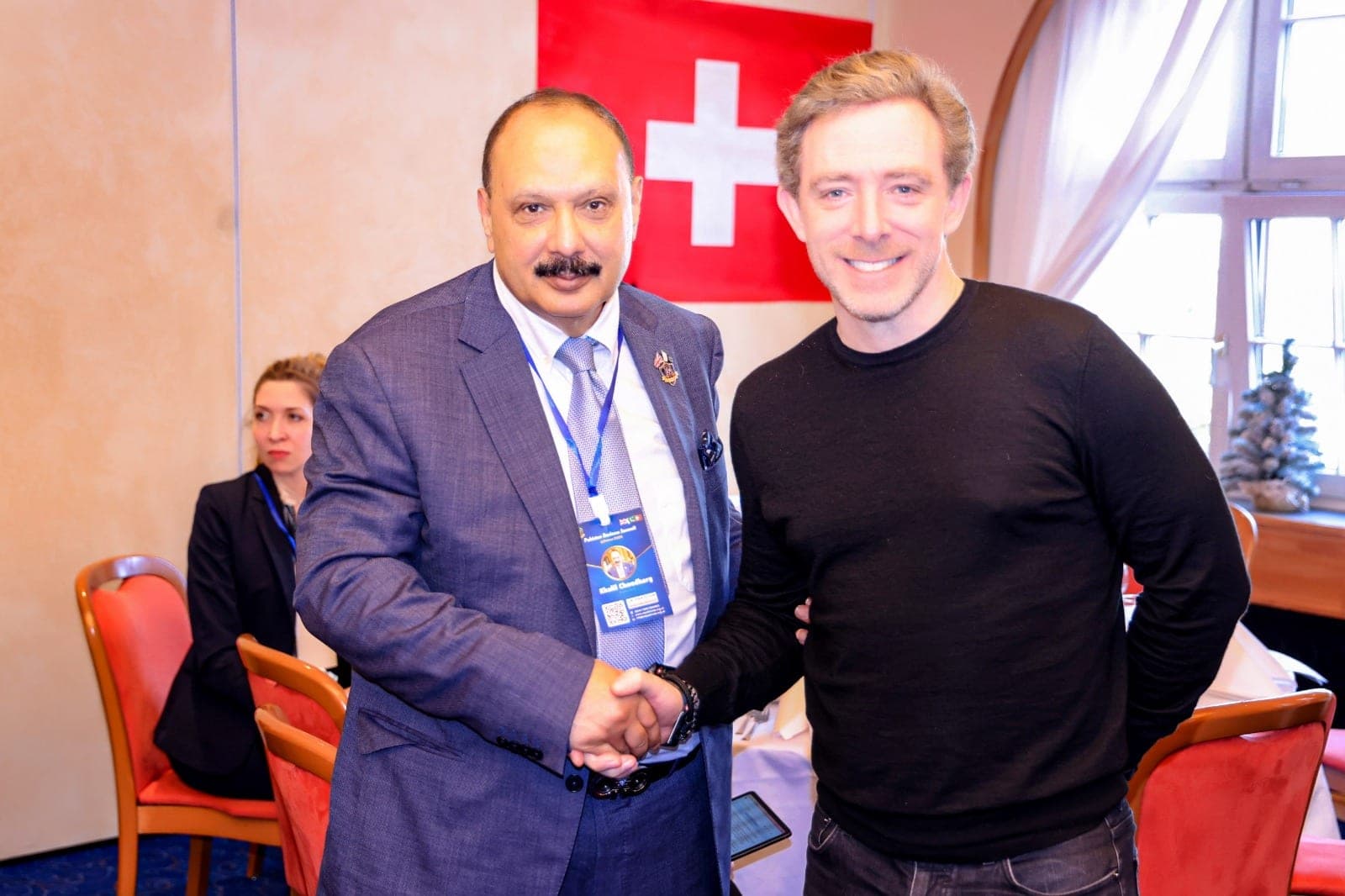 Two delegates shaking hands at a business summit