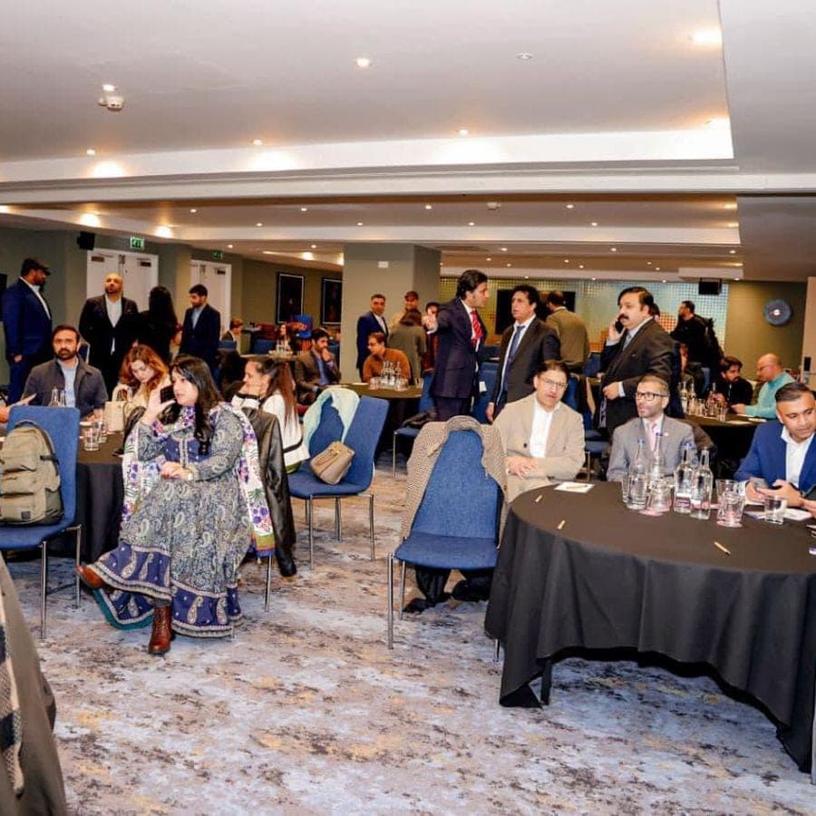 Guests mingling between tables at a networking event