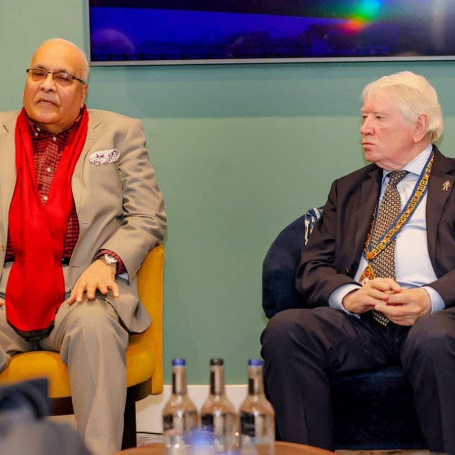 Two business leaders in conversation during a forum