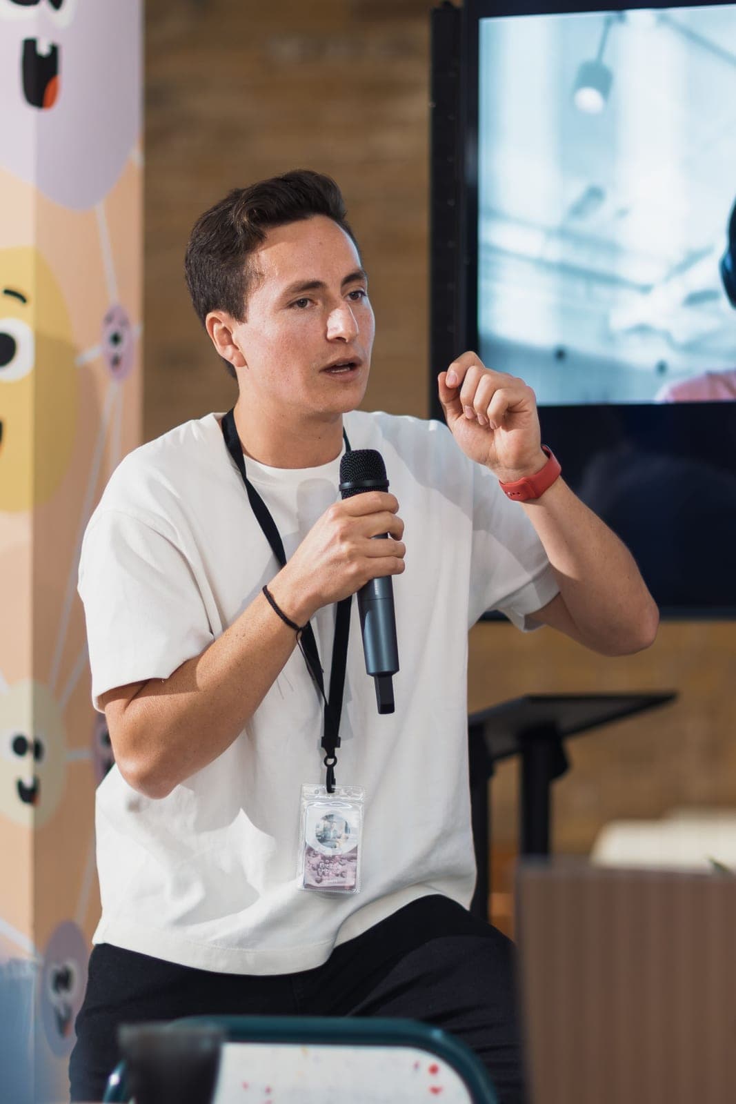 A young founder pitching with a microphone