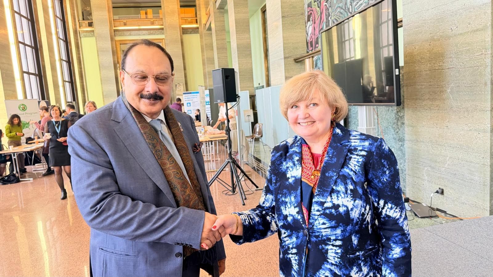 Two delegates shaking hands at a business event
