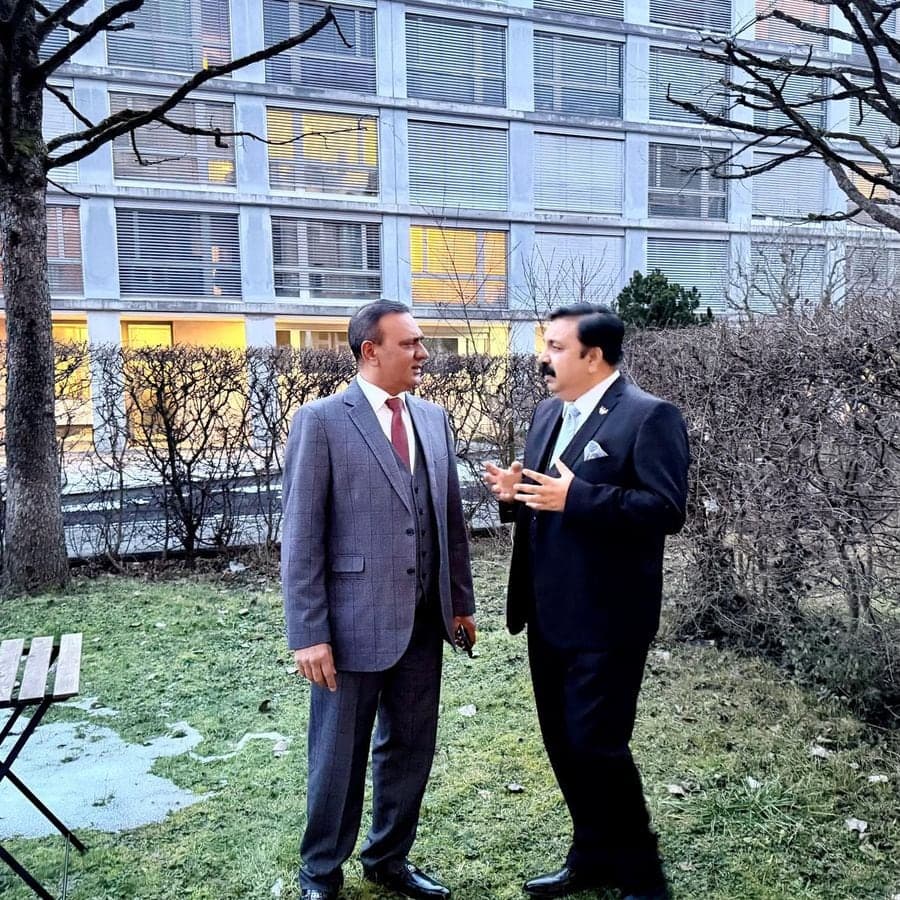 Two delegates in conversation outdoors