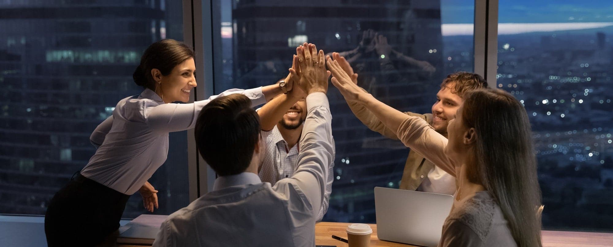 A business team celebrating together around a table